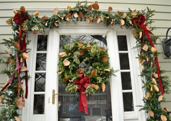 Christmas greenery decorating front entrance of a house