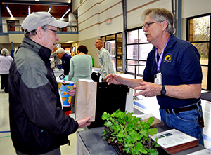 Master Gardener talking with customer at Healthy Yards Expo