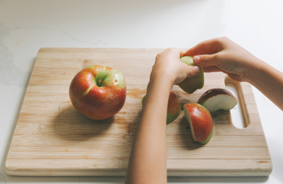 hands slicing apples