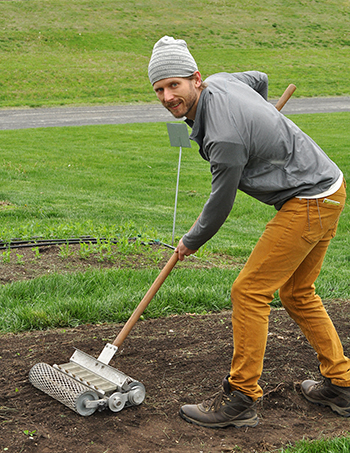 Hort agent Zac Hoppenstedt uses a 6-row seeder to plant carrot seed