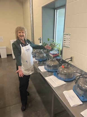 Nancy Carr School Enrichment Coordinator cleaning incubators