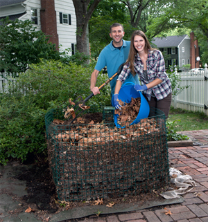 Woman and man building a compost pile