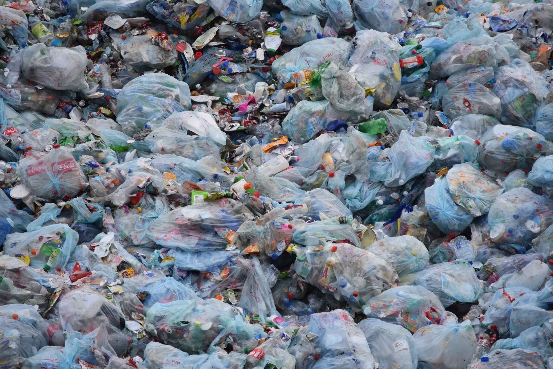 piles of plastic trash in a landfill 