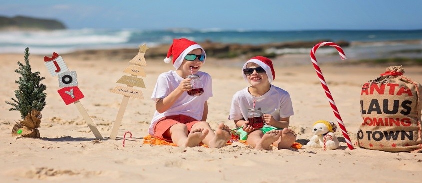 family sitting on the beach in Australia winter holiday 
